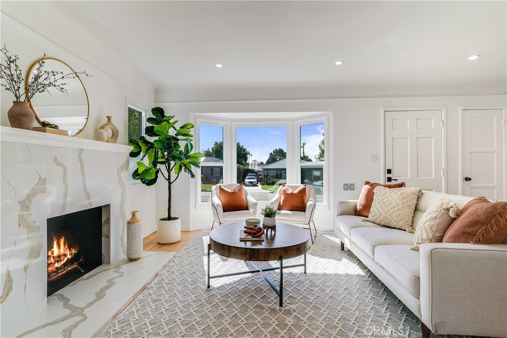775 Morada Place Altadena, CA 91001 - Photo 3 of 32 a living room with furniture a fireplace and a potted plant