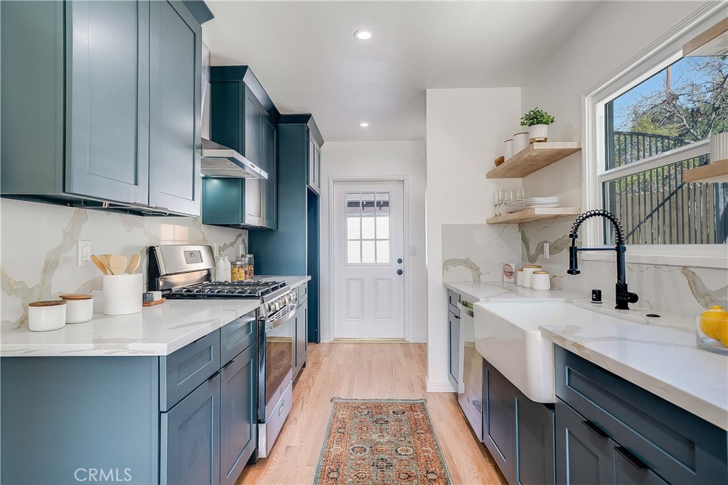 775 Morada Place Altadena, CA 91001 - Photo 5 of 32 a kitchen with a sink stove and cabinets