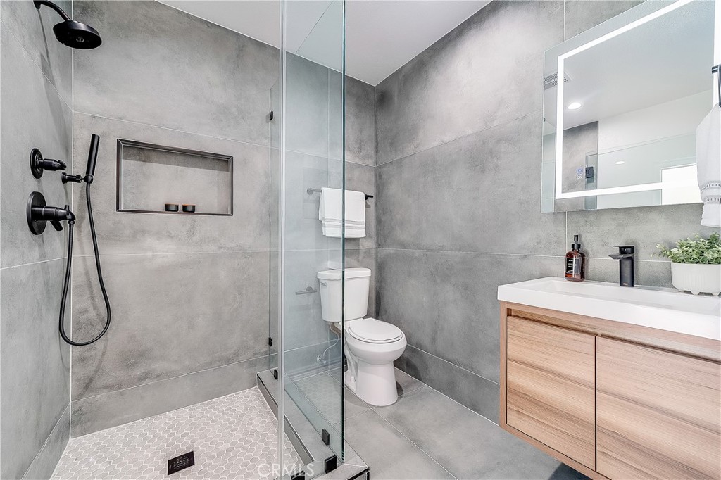 775 Morada Place Altadena, CA 91001 - Photo 8 of 32 a bathroom with a granite countertop toilet sink and shower