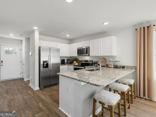 a large kitchen with lots of counter space and stainless steel appliances