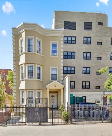 a front view of a residential apartment building with a yard