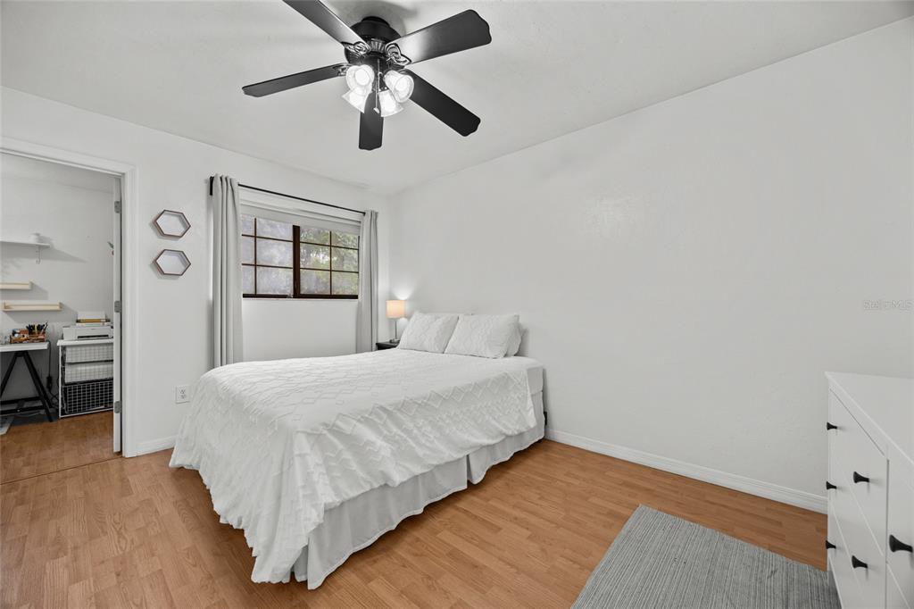 5733 Southwest 10th Place Gainesville, FL 32607 - Photo 12 of 23 a bedroom with a bed and a chandelier