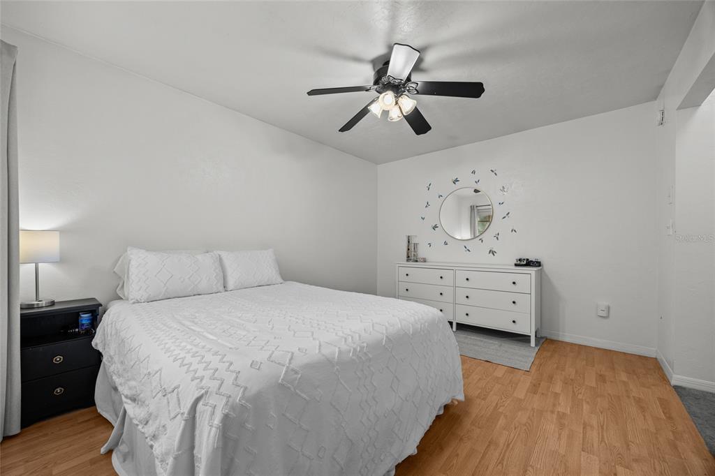 5733 Southwest 10th Place Gainesville, FL 32607 - Photo 14 of 23 a bedroom with a bed and a chandelier