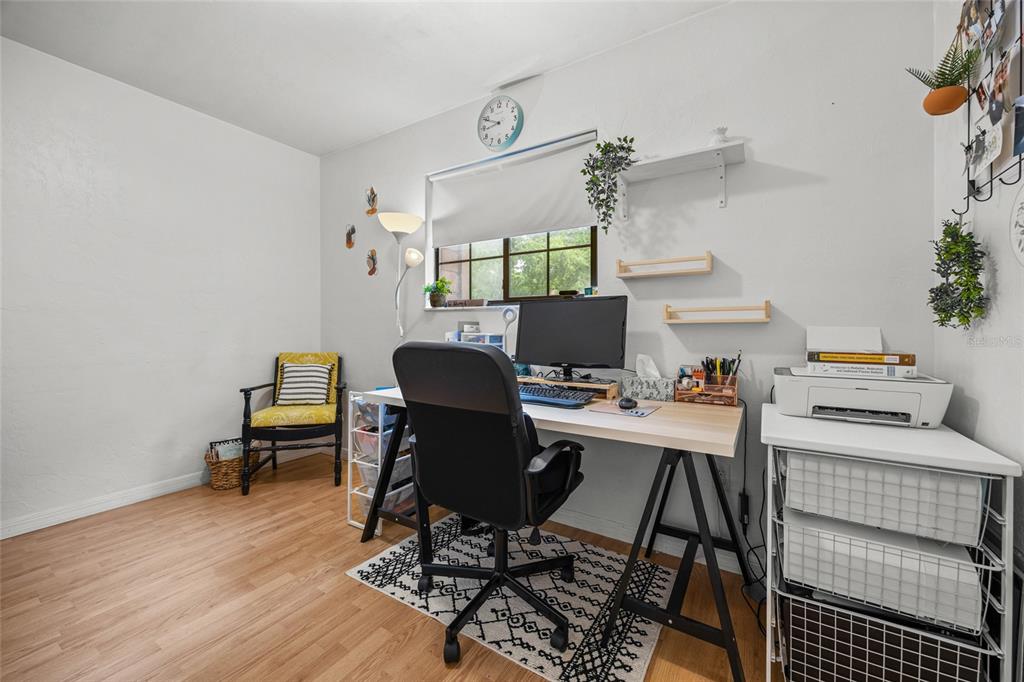 5733 Southwest 10th Place Gainesville, FL 32607 - Photo 16 of 23 a workspace with furniture and wooden floor
