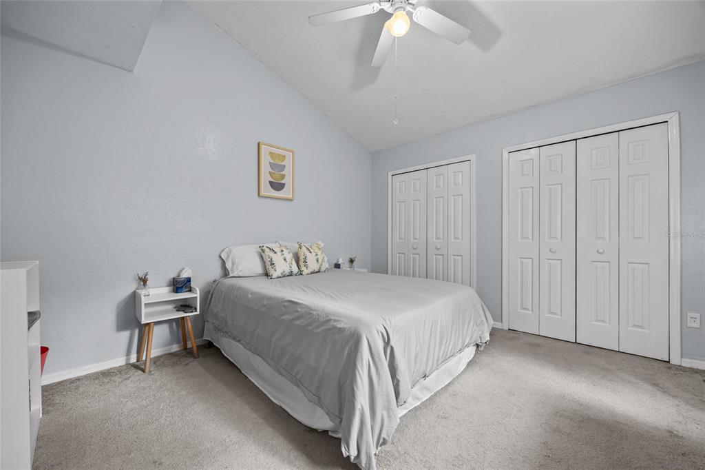 5733 Southwest 10th Place Gainesville, FL 32607 - Photo 17 of 23 a bedroom with a bed and a chandelier