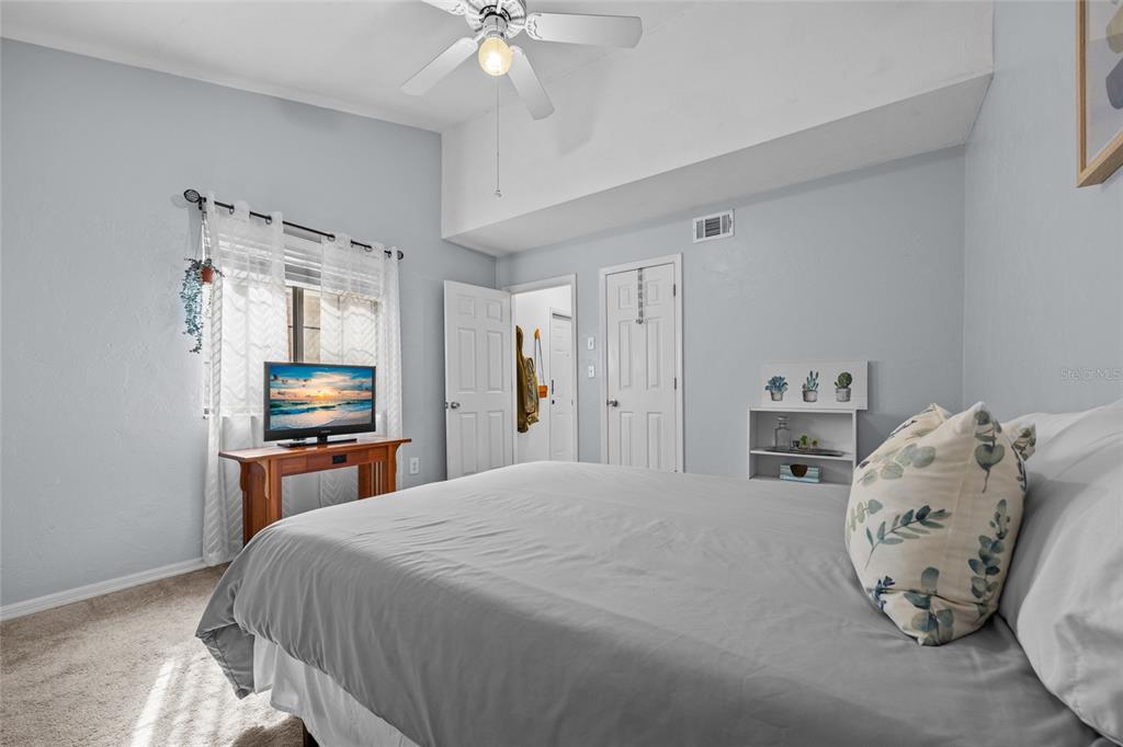 5733 Southwest 10th Place Gainesville, FL 32607 - Photo 18 of 23 a bedroom with a bed and a chair