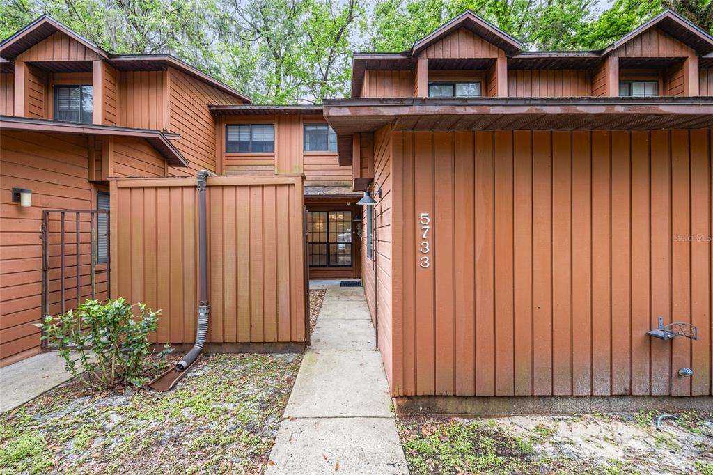 5733 Southwest 10th Place Gainesville, FL 32607 - Photo 2 of 23 a view of a house with wooden fence