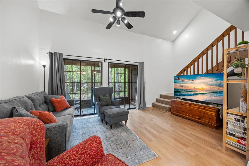 5733 Southwest 10th Place Gainesville, FL 32607 - Photo 5 of 23 a living room with furniture and a flat screen tv