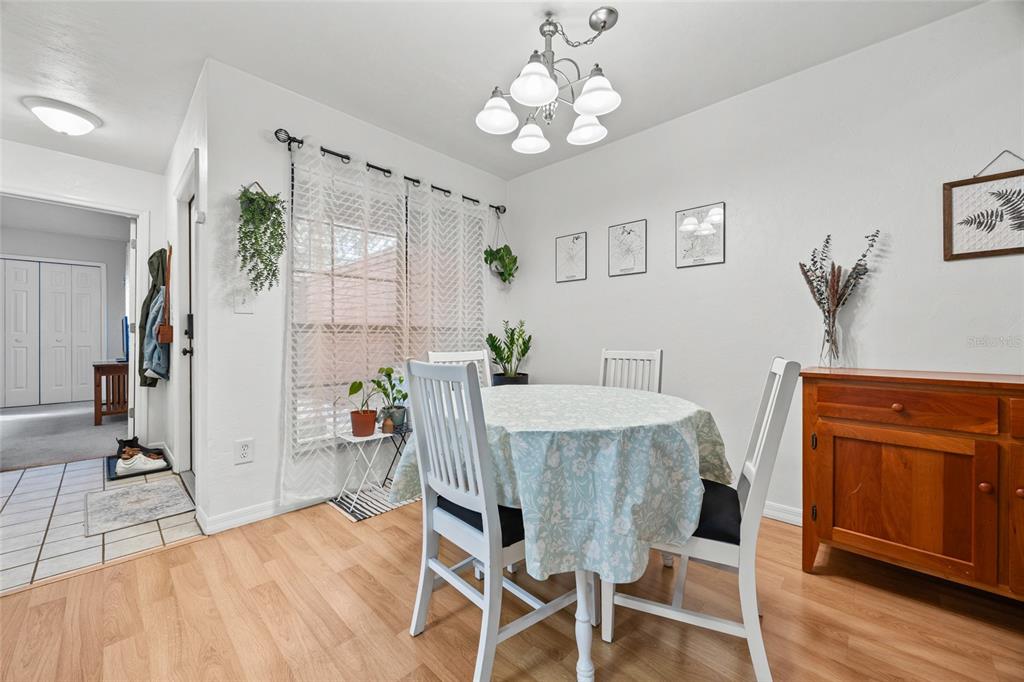 5733 Southwest 10th Place Gainesville, FL 32607 - Photo 8 of 23 a view of a dining room with furniture and wooden floor