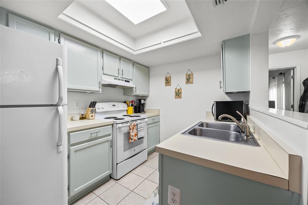 5733 Southwest 10th Place Gainesville, FL 32607 - Photo 9 of 23 a kitchen with cabinets appliances and a counter space