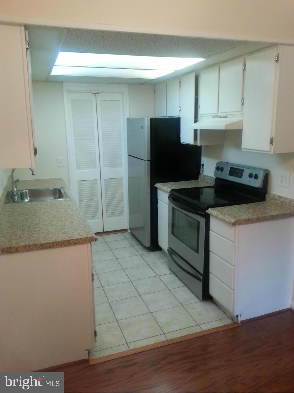 11627 Stoneview Square, Unit 21C Reston, VA 20191 - Photo 11 of 19 a kitchen with stainless steel appliances granite countertop a sink and a stove top oven