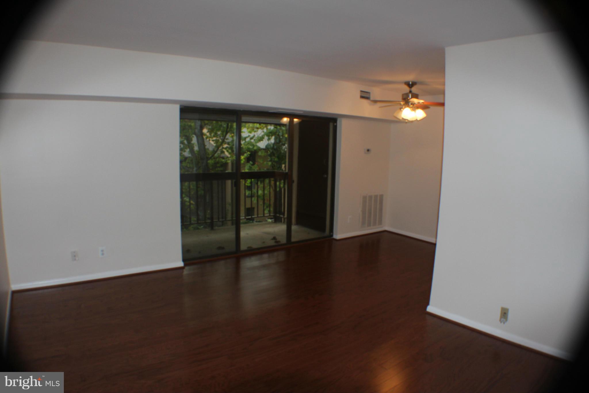 11627 Stoneview Square, Unit 21C Reston, VA 20191 - Photo 14 of 19 wooden floor in an empty room with a window
