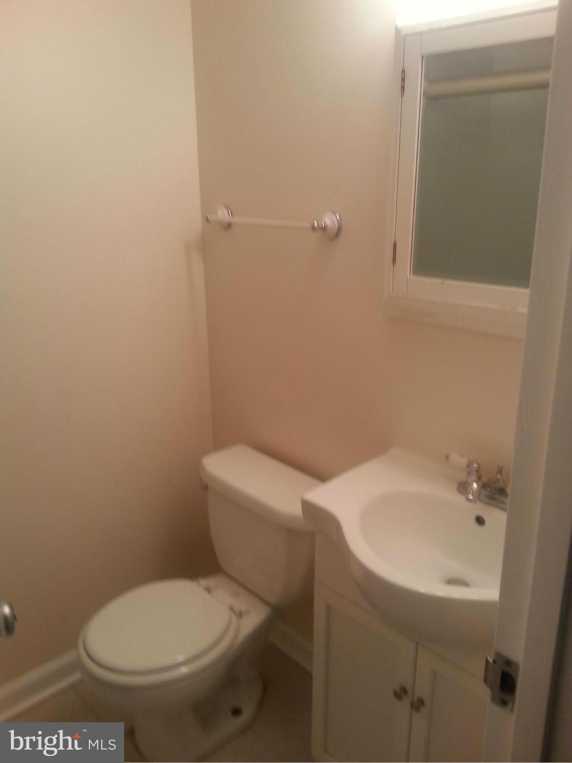 11627 Stoneview Square, Unit 21C Reston, VA 20191 - Photo 3 of 19 a white toilet sitting next to a white sink