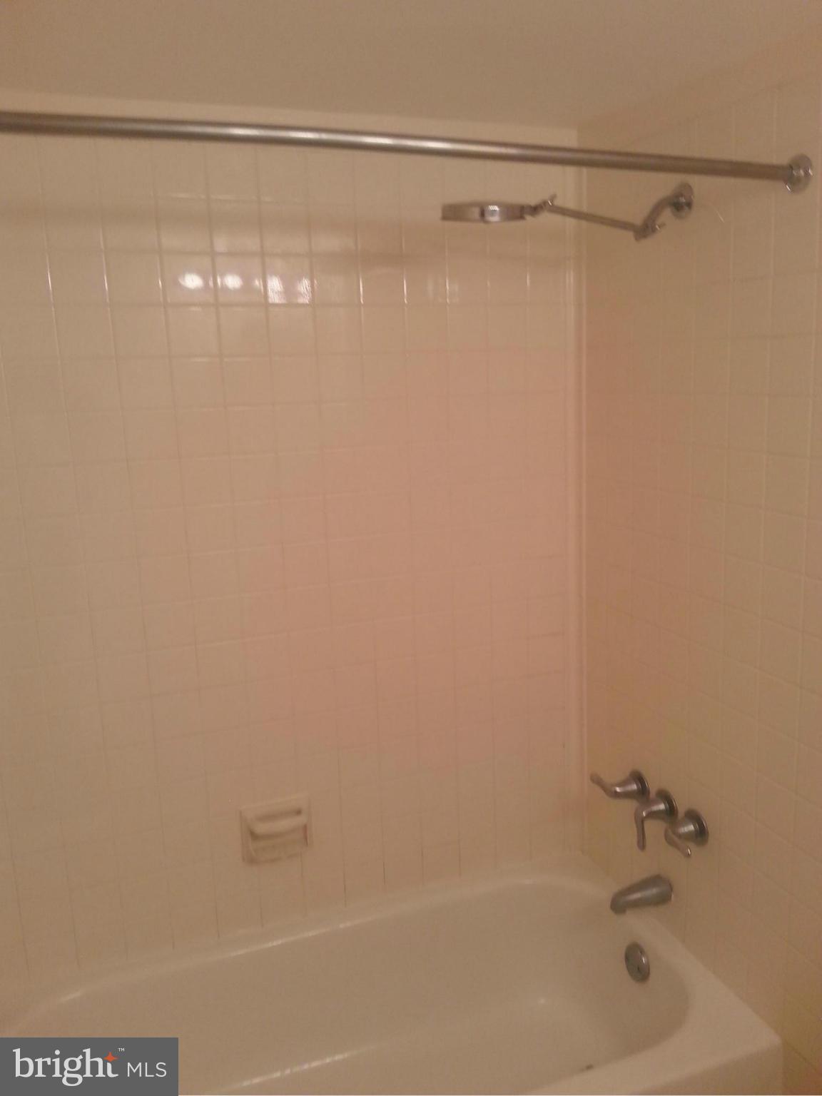 11627 Stoneview Square, Unit 21C Reston, VA 20191 - Photo 7 of 19 a bathroom with a shower and a bath tub