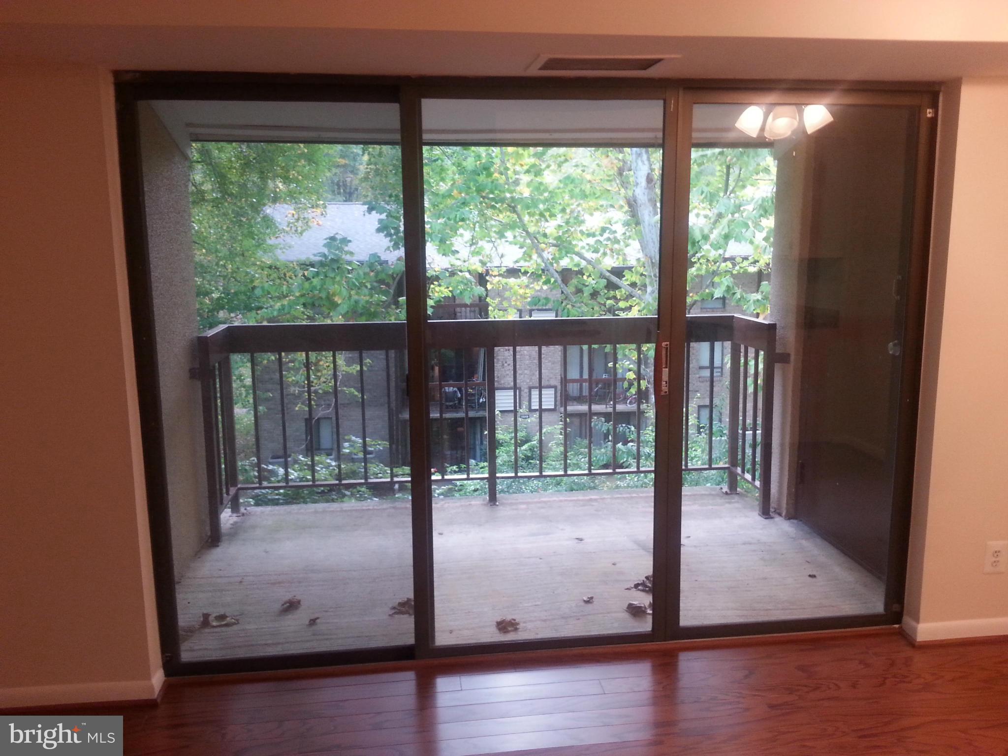 11627 Stoneview Square, Unit 21C Reston, VA 20191 - Photo 9 of 19 a view of empty room with wooden floor and fan