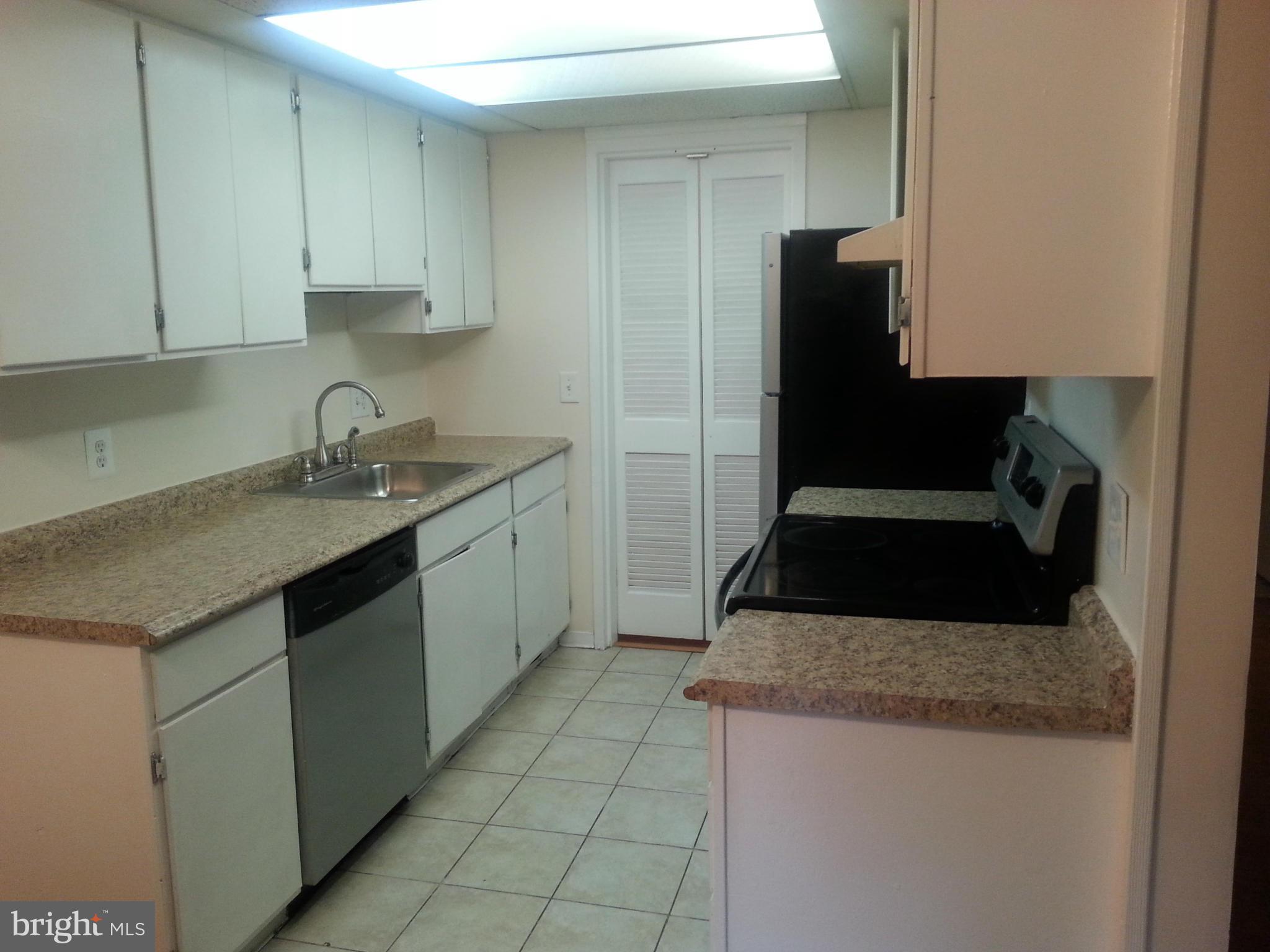 11627 Stoneview Square, Unit 21C Reston, VA 20191 - Photo 10 of 19 a kitchen with a sink stove and refrigerator