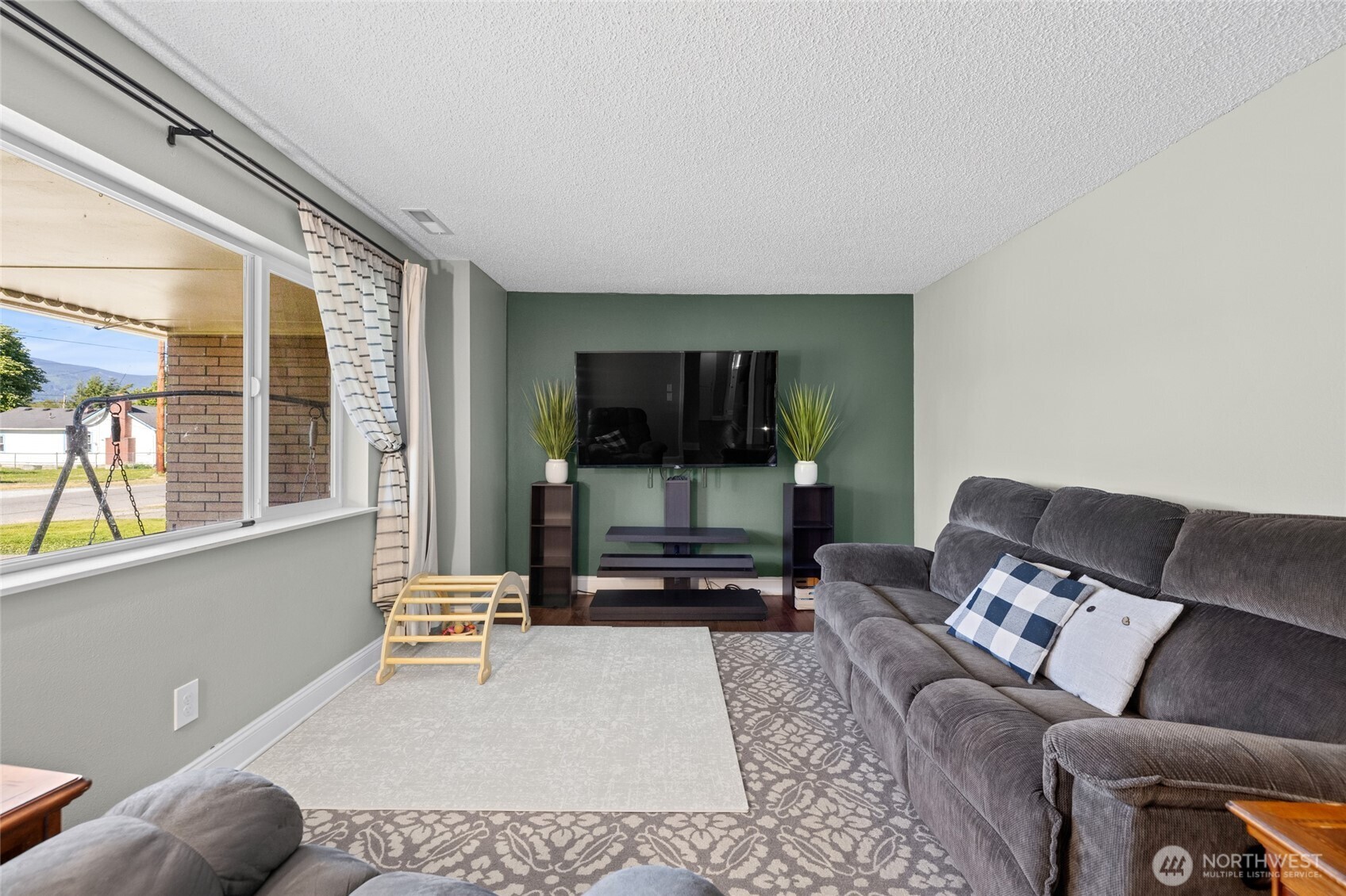 415 Sterling Street Sedro-Woolley, WA 98284 - Photo 9 of 38 a living room with furniture and a flat screen tv