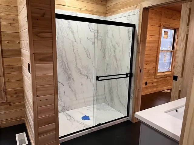 a bathroom with a shower and a sink
