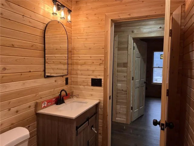 a bathroom with a sink a toilet and mirror