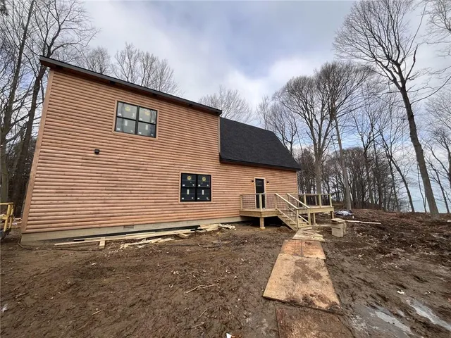a backyard of a house with fire pit and trees