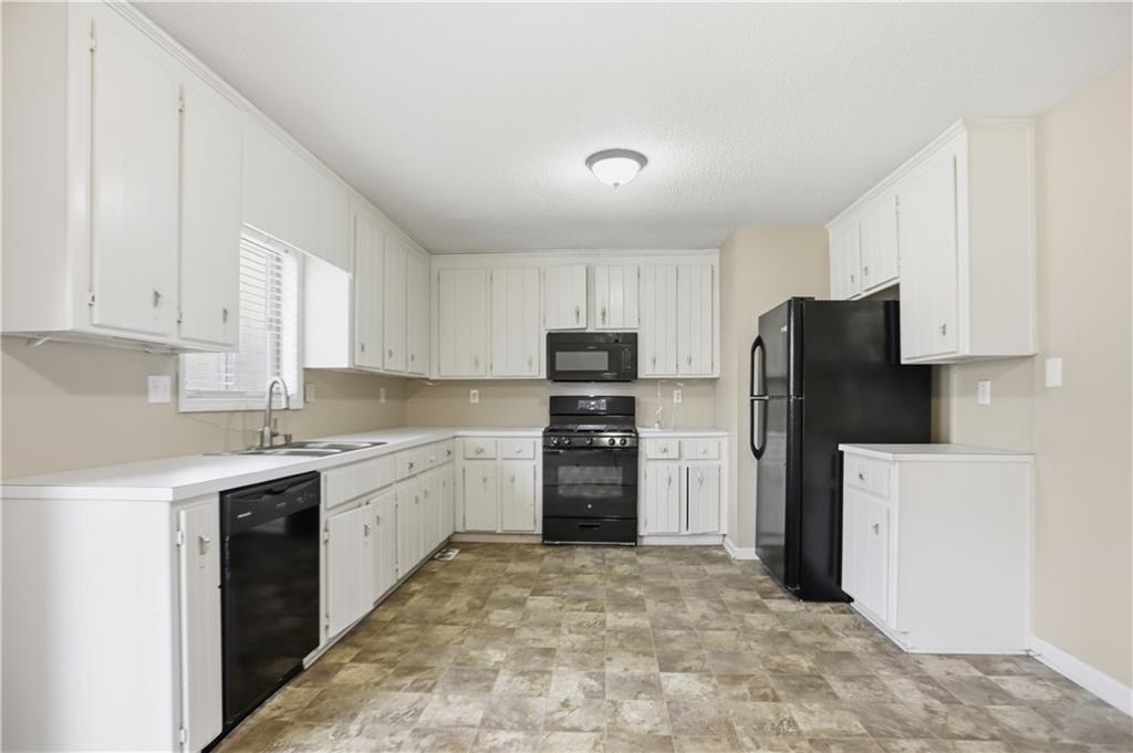 4899 Hawk Trail Marietta, GA 30066 - Photo 13 of 35 a kitchen with a refrigerator sink and stove top oven