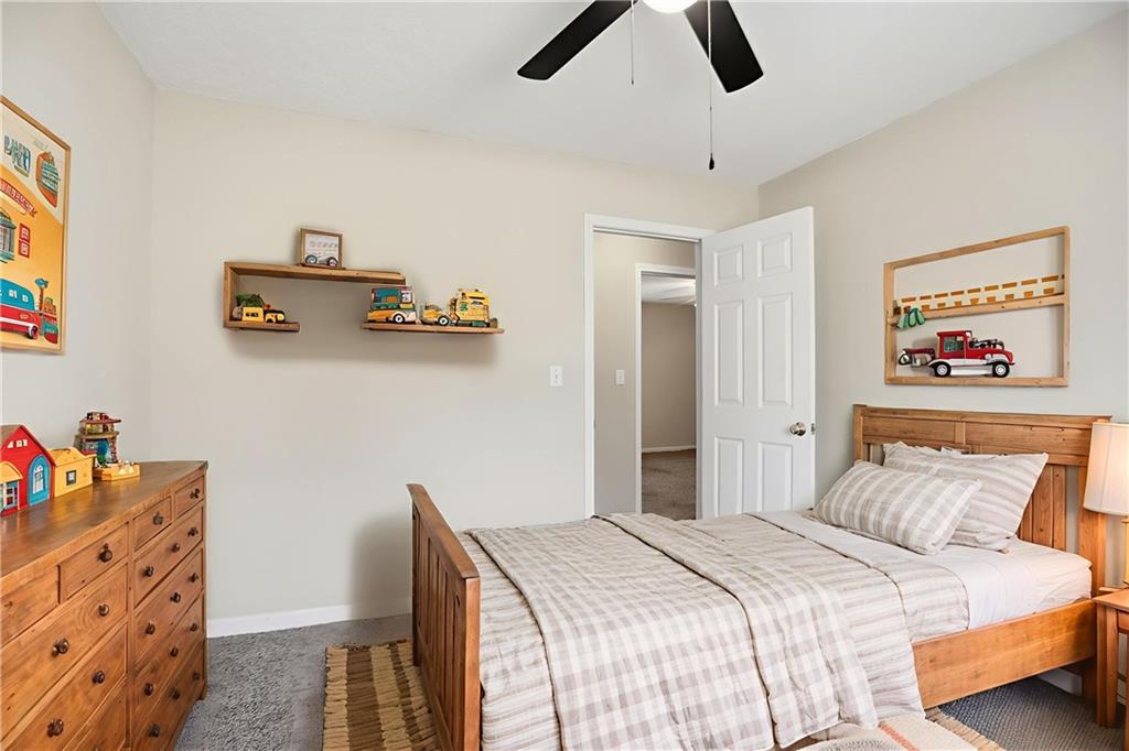 4899 Hawk Trail Marietta, GA 30066 - Photo 6 of 35 a bedroom with a bed and wooden floor