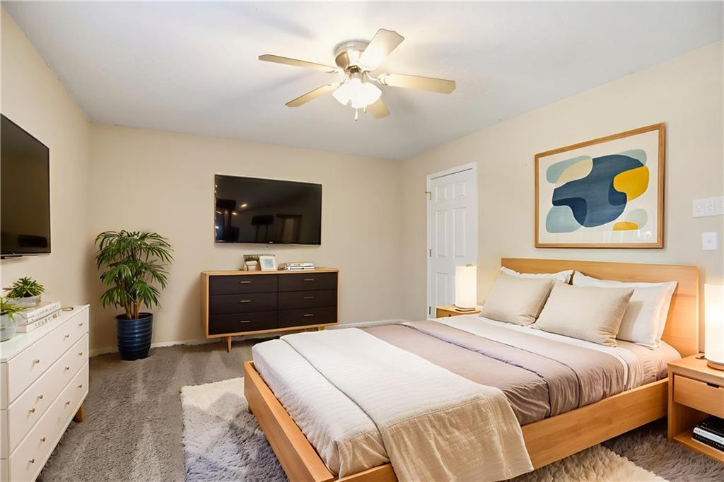 4899 Hawk Trail Marietta, GA 30066 - Photo 7 of 35 a bedroom with a bed and a flat screen tv