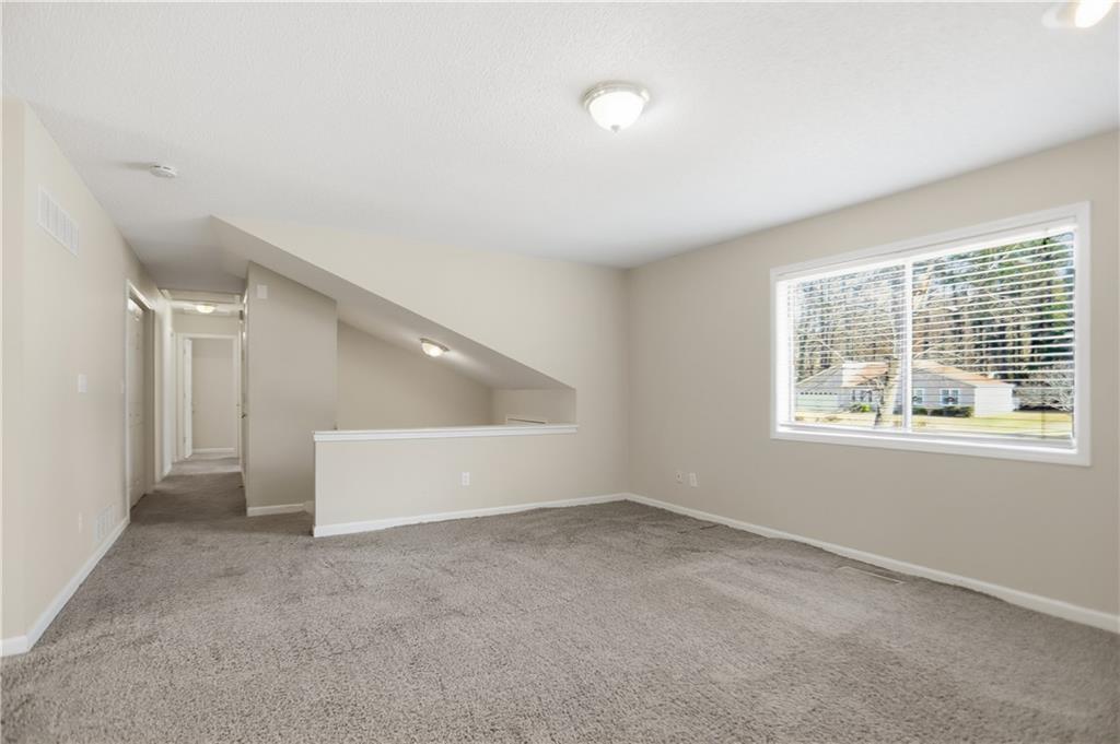 4899 Hawk Trail Marietta, GA 30066 - Photo 10 of 35 an empty room with windows