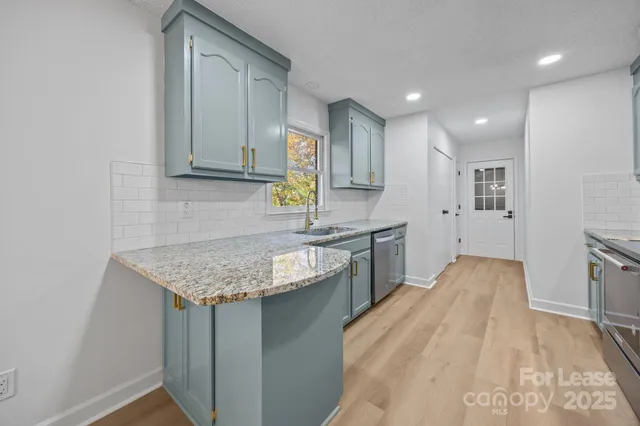 a kitchen with a sink stove and cabinets
