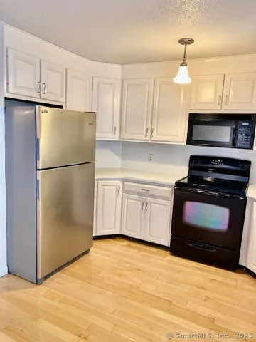 a bathroom with a tub a sink and a large mirror