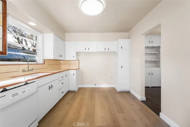 a view of a kitchen with wooden floor