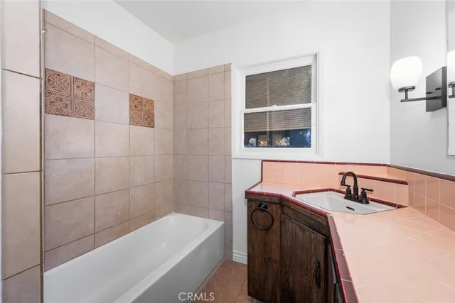 a bathroom with a sink a bathtub and a shower