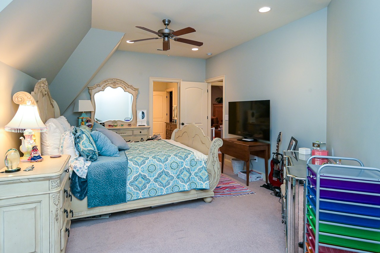 205 Nature Ridge Road Tullahoma, TN 37388 - Photo 38 of 58 a living room with furniture a flat screen tv and a chandelier