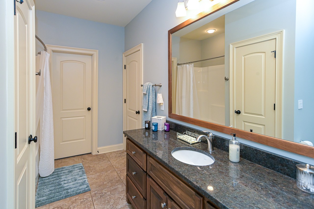 205 Nature Ridge Road Tullahoma, TN 37388 - Photo 39 of 58 a bathroom with a granite countertop sink and a mirror