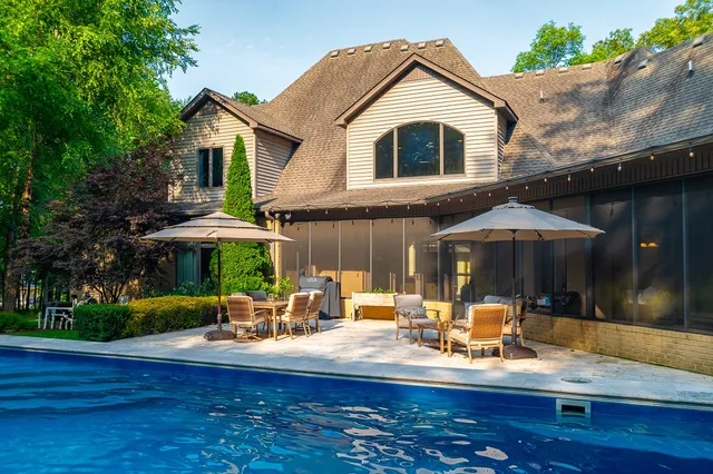 an aerial view of a house with a yard and outdoor seating