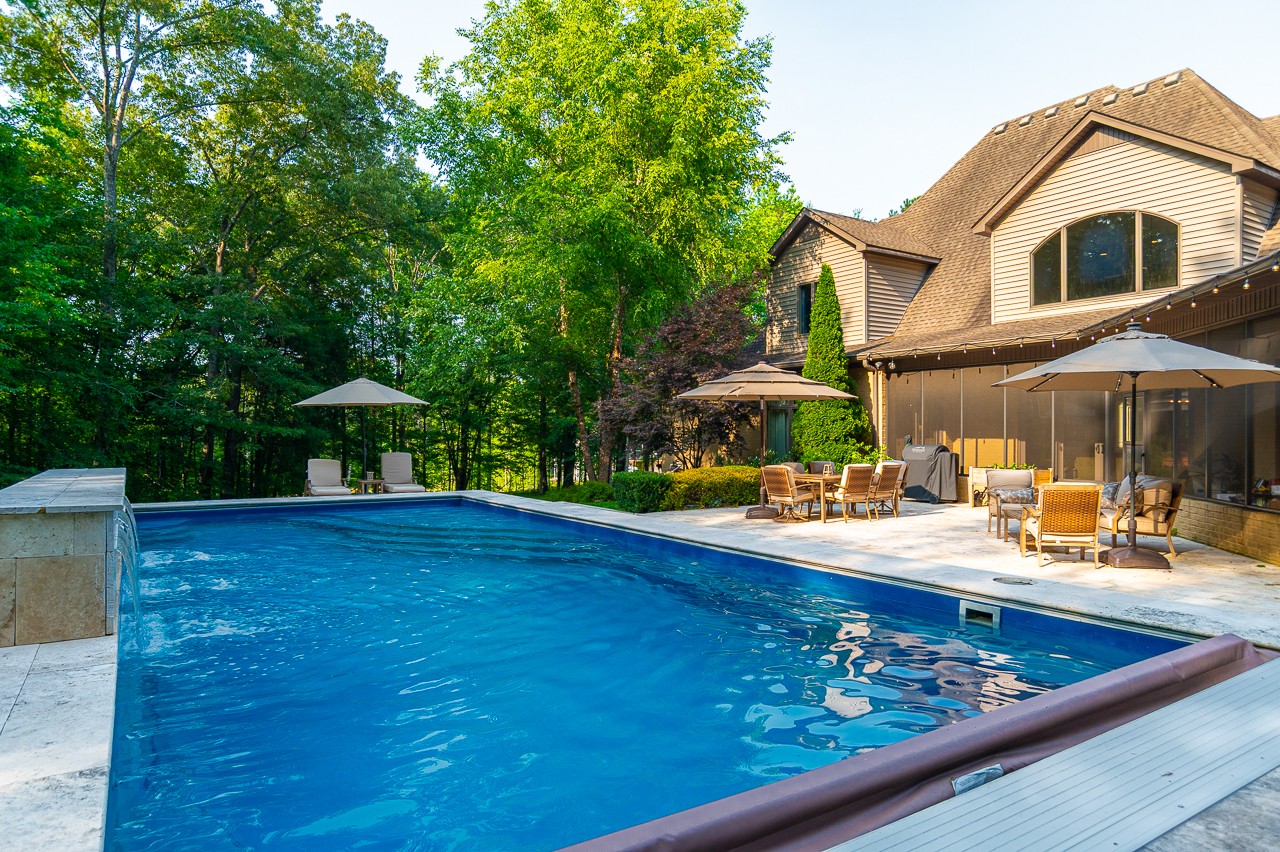 205 Nature Ridge Road Tullahoma, TN 37388 - Photo 53 of 58 a view of a house with pool and chairs under an umbrella