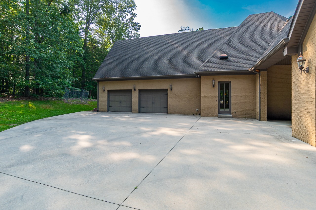 205 Nature Ridge Road Tullahoma, TN 37388 - Photo 7 of 58 a view of a house with a yard and garage