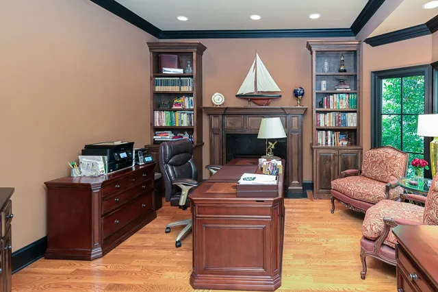 a living room with furniture a fireplace and a bookshelf