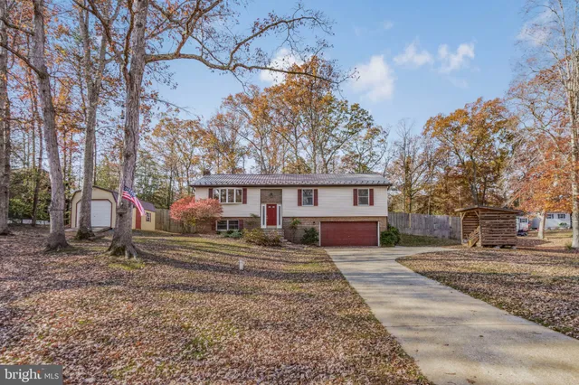 a view of a house with a yard covered in snow