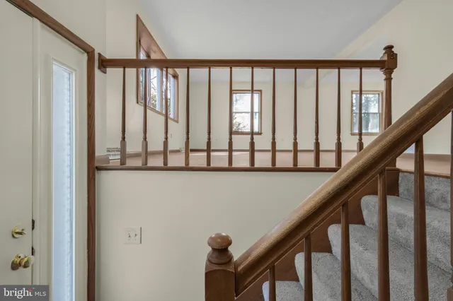 a view of staircase with railing and stairs