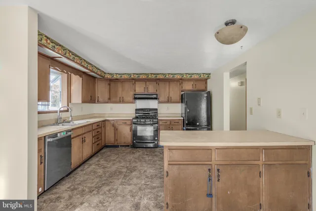 a kitchen with a sink cabinets and stainless steel appliances