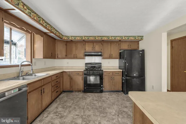 a kitchen with a refrigerator and a sink