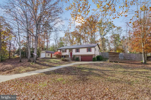 a view of a house with a yard covered in snow