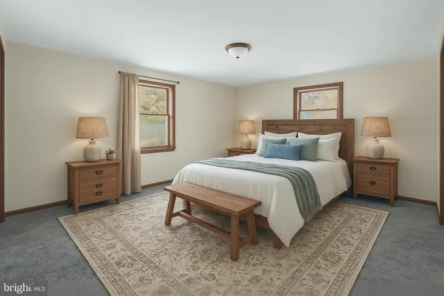 a bedroom with a bed a table and painting on the wall