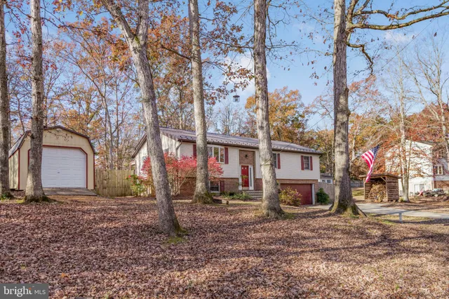 a view of a house with a yard and garage