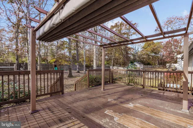 a view of a porch with wooden floor and iron stairs