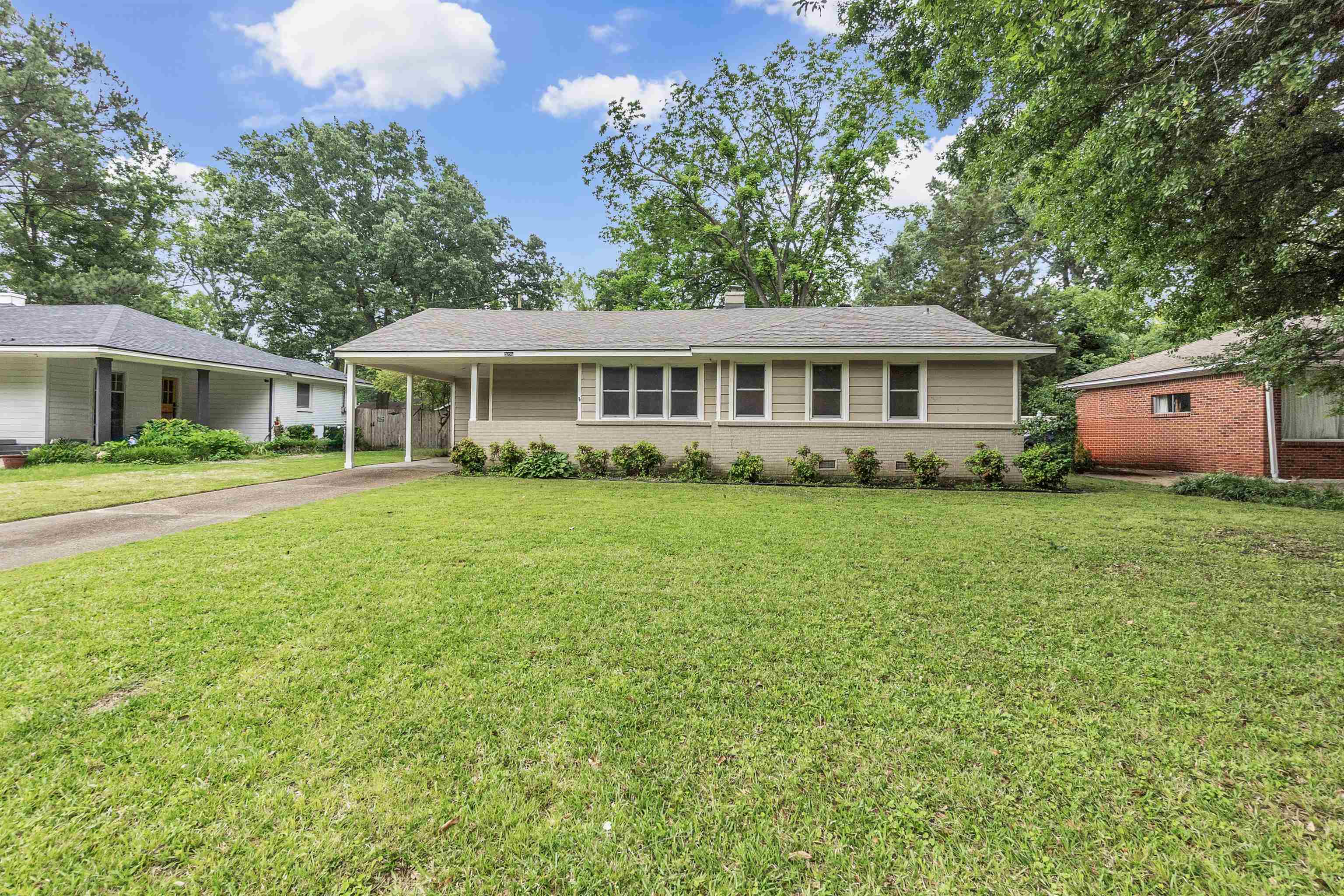 5251 Sequoia Road Memphis, TN 38120 - Photo 1 of 21 a front view of a house with a garden