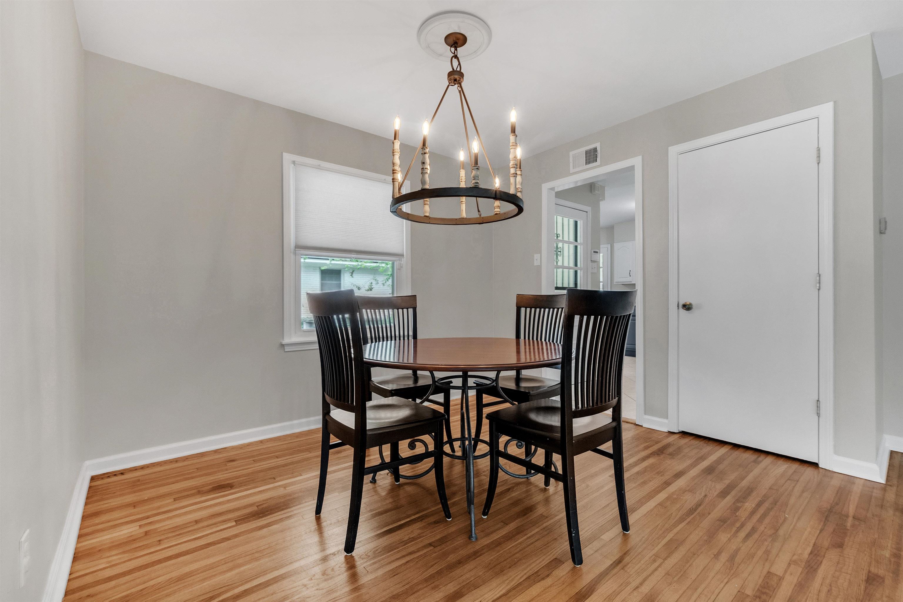 5251 Sequoia Road Memphis, TN 38120 - Photo 20 of 21 a view of a dining room with furniture wooden floor and chandelier