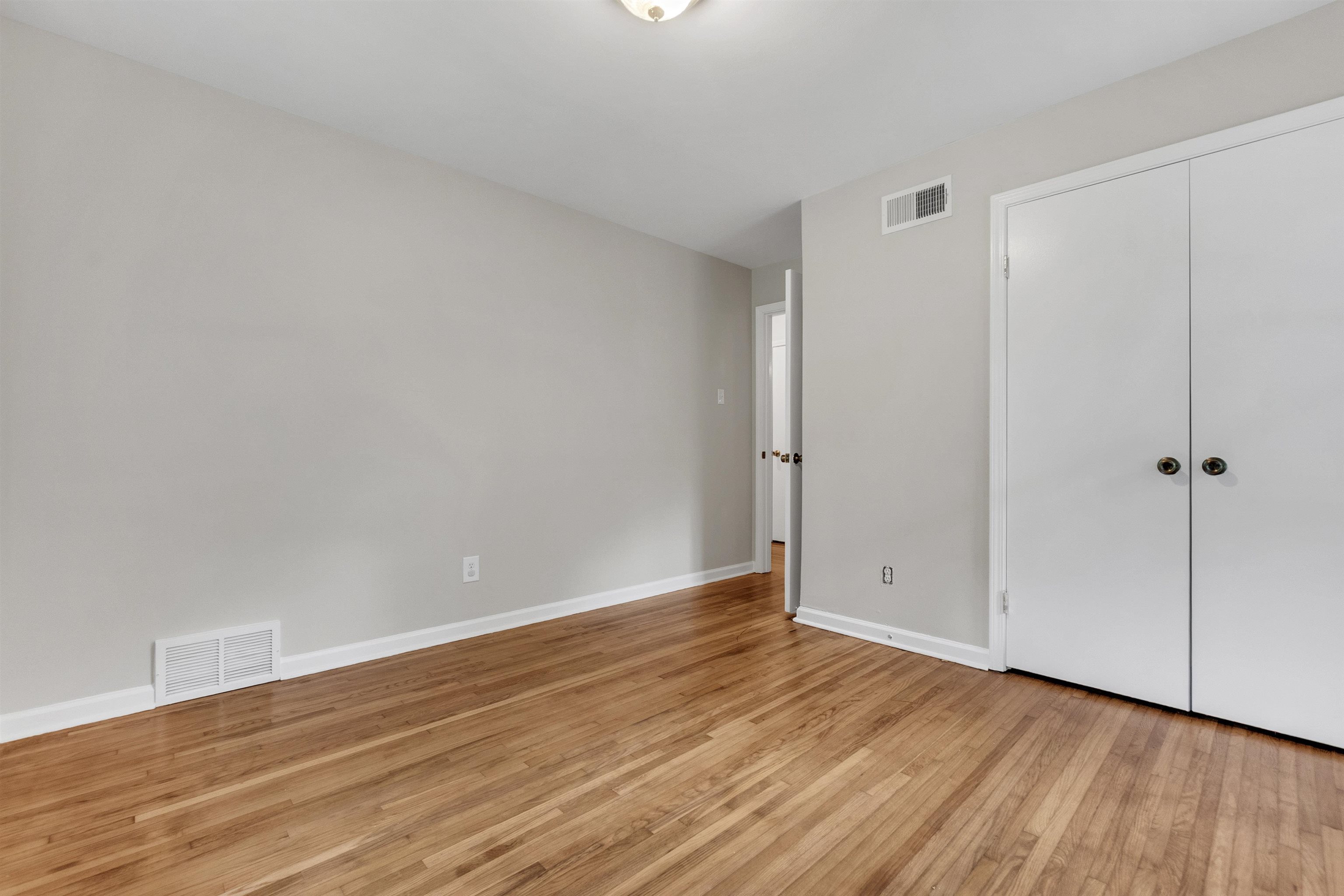 5251 Sequoia Road Memphis, TN 38120 - Photo 7 of 21 a view of an empty room with wooden floor
