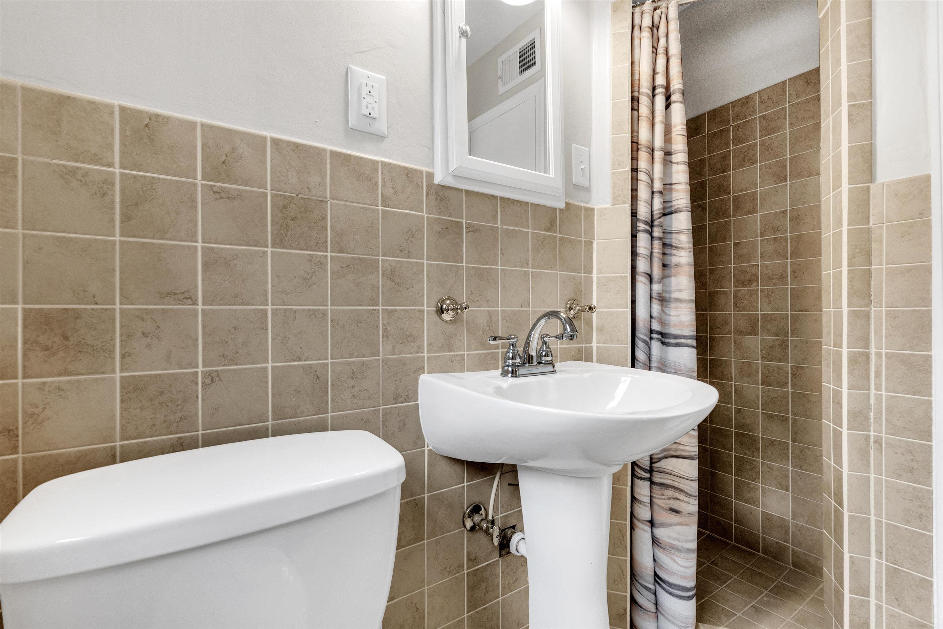 5251 Sequoia Road Memphis, TN 38120 - Photo 8 of 21 a bathroom with a sink a toilet and shower